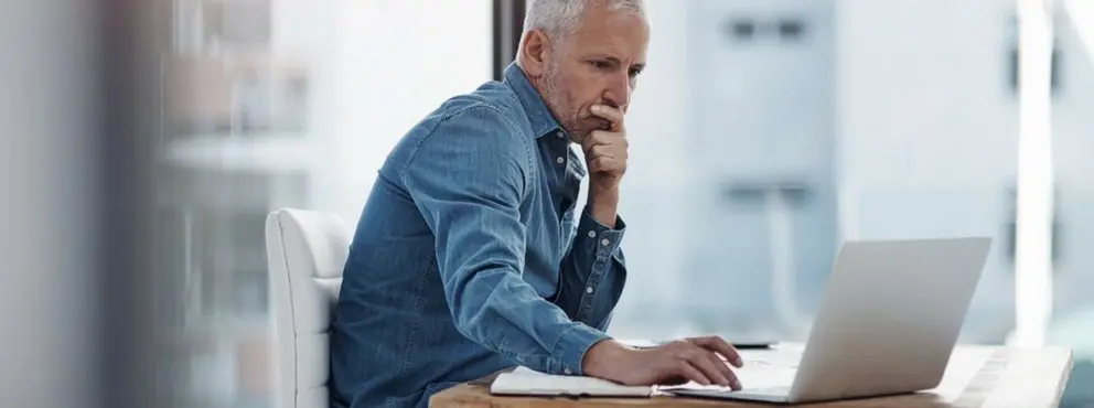 man looking worried at his computer
